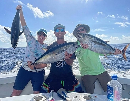 Three men pose with their catches