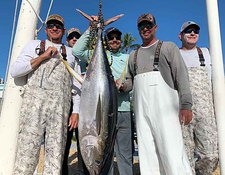 Group of men pose with their catch